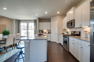 Island with sink open to nook and family room
