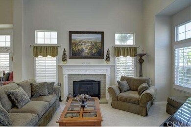 SUNLIT LIVING ROOM WITH FIREPLACE OPENS TO FORMAL 