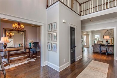 From the Foyer the Formal Dining Room to the left and the 2-Story Great Room ahead -- The doors have been stained, door handles updated to oval shaped sand cast bronze, & all of the trim on this level has been removed & new trim installed.
