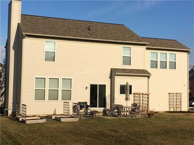 Exterior Back. Rear view of home with custom garden boxes and trellis.  Large concrete/paver patio  area for outside entertaining.