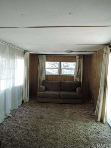 LIVING ROOM WITH COUCH AND DRAPES