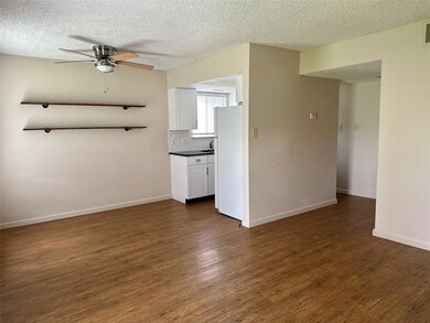 Unfurnished living room with ceiling fan, a textu