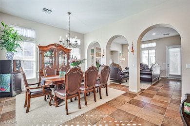 Dining area with a chandelier and arched walkways