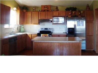 Kitchen island has eating space. Stainless steel a