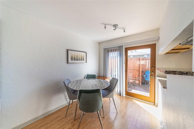 Dining room featuring a textured wall, light wood 