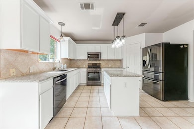 Kitchen featuring appliances with stainless steel