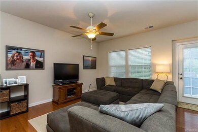 FAMILY ROOM WITH HARDWOODS AND CEILING FAN