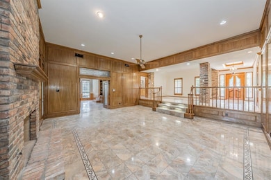 Spacious living area with a gorgeous brick fireplace.