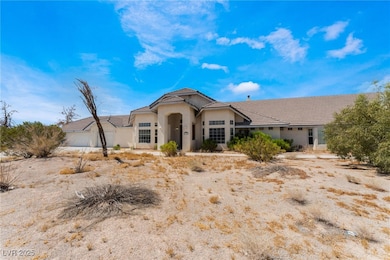 View of front facade featuring a garage, stucco si