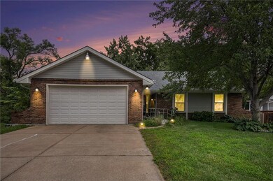 Ranch-style house featuring driveway, brick siding, a front lawn, and a garage