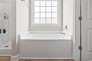 Full bath featuring wood finished floors, walk in 