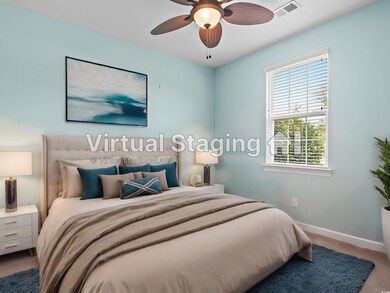 Carpeted bedroom with ceiling fan