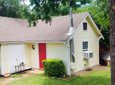 View of front of property featuring a shingled ro