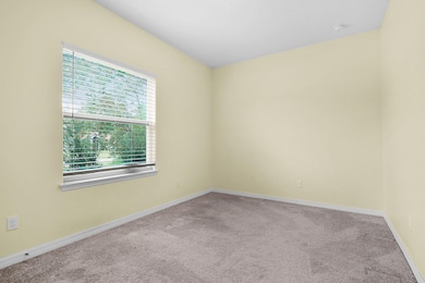 Unfurnished room with carpet and baseboards