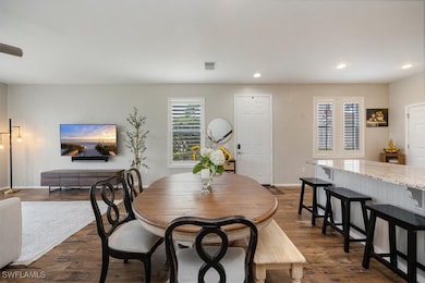 Dining room with recessed lighting, dark wood-styl