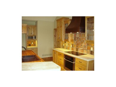 Kitchen features limestone & Brazilian walnut coun