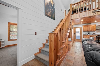 Stairs with baseboards and a towering ceiling