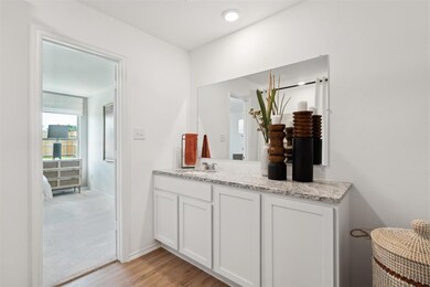 Bathroom featuring wood finished floors, vanity, a