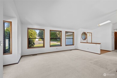 Living room has many windows for natural light.