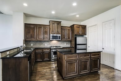 Chef inspired kitchen featuring granite counters,