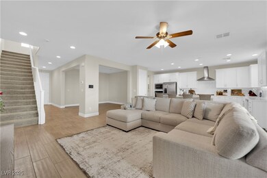 Living area featuring visible vents, stairs, light