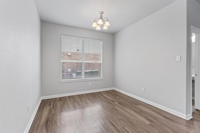 Unfurnished room featuring a chandelier and dark 