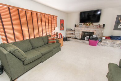 Good sized living room with beautiful fireplace.