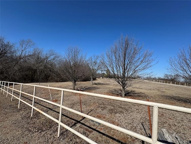 View of yard featuring a rural view and fence