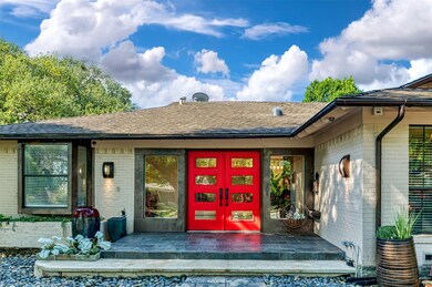 Doorway to property featuring brick siding, a shingled roof, french doors, and a patio area