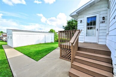 Back deck leading to the 2 car detached garage.
