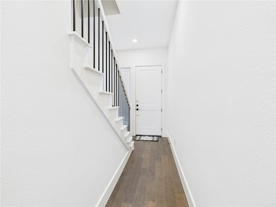 Hall featuring dark wood-style flooring, recessed