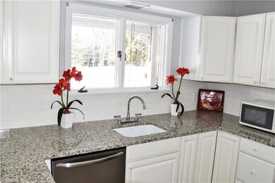 The freshly-painted kitchen with stylish granite c