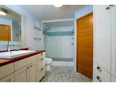 Bathroom. Beautifully tiled stall shower with rive