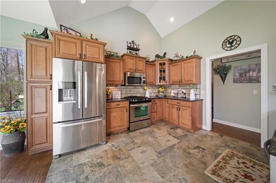 Open eat-in kitchen with breakfast area and bar. 2