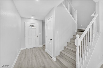 Entrance foyer with visible vents, baseboards, lig