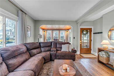 Living room with a wealth of natural light and light wood-type flooring