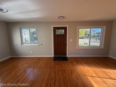 Entryway with light wood-type flooring and baseboards
