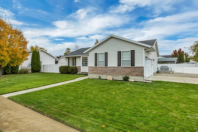 View of front of house with driveway, a garage, and brick siding