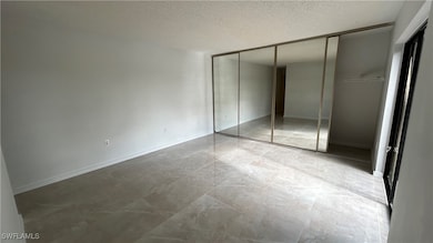 Unfurnished bedroom with a textured ceiling and a