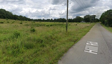 View of asphalt street with a view of rural / pastoral area