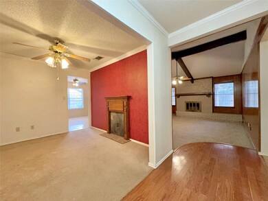Unfurnished living room featuring a textured ceili
