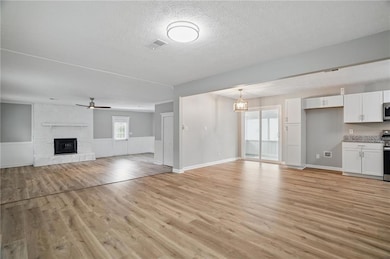 Unfurnished living room featuring a textured ceili