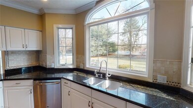Another view of kitchen. Bright window overlooks n