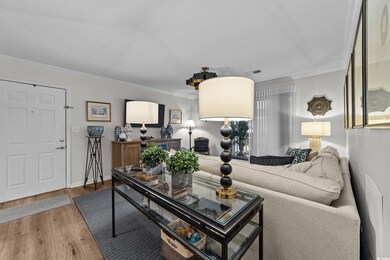 Living room featuring crown molding, wood finished