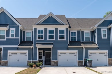 Townhome / multi-family property with roof with sh