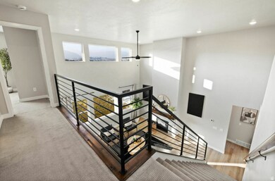 Stairway with recessed lighting and wood finished floors