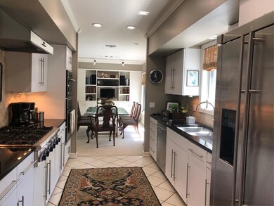Kitchen with sink, fridge, dishwasher, backsplash,