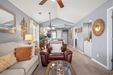 Carpeted living room featuring lofted ceiling and 
