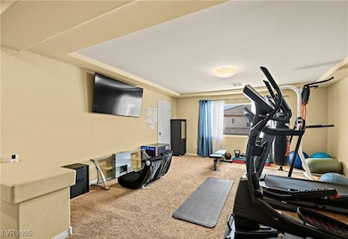 Workout room with light colored carpet and baseboards