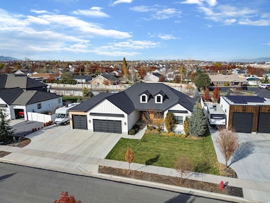 View of front facade featuring a residential view, driveway, and a garage
